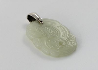 Appraisal: A Chinese white jade pendent carved on each side with