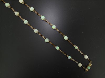 Appraisal: An opal necklace mounted with round opal beads and crystal