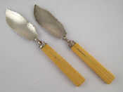 Appraisal: A pair of William IV silver butter knives with reeded