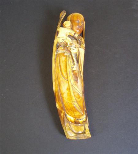 Appraisal: A th century Chinese stained ivory Guanyin figure holding a