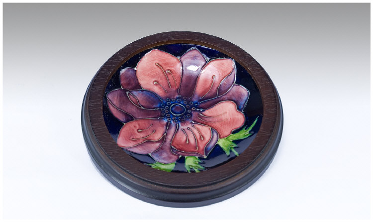 Appraisal: Moorcroft Dish within a circular wooden frame Anemone Range on