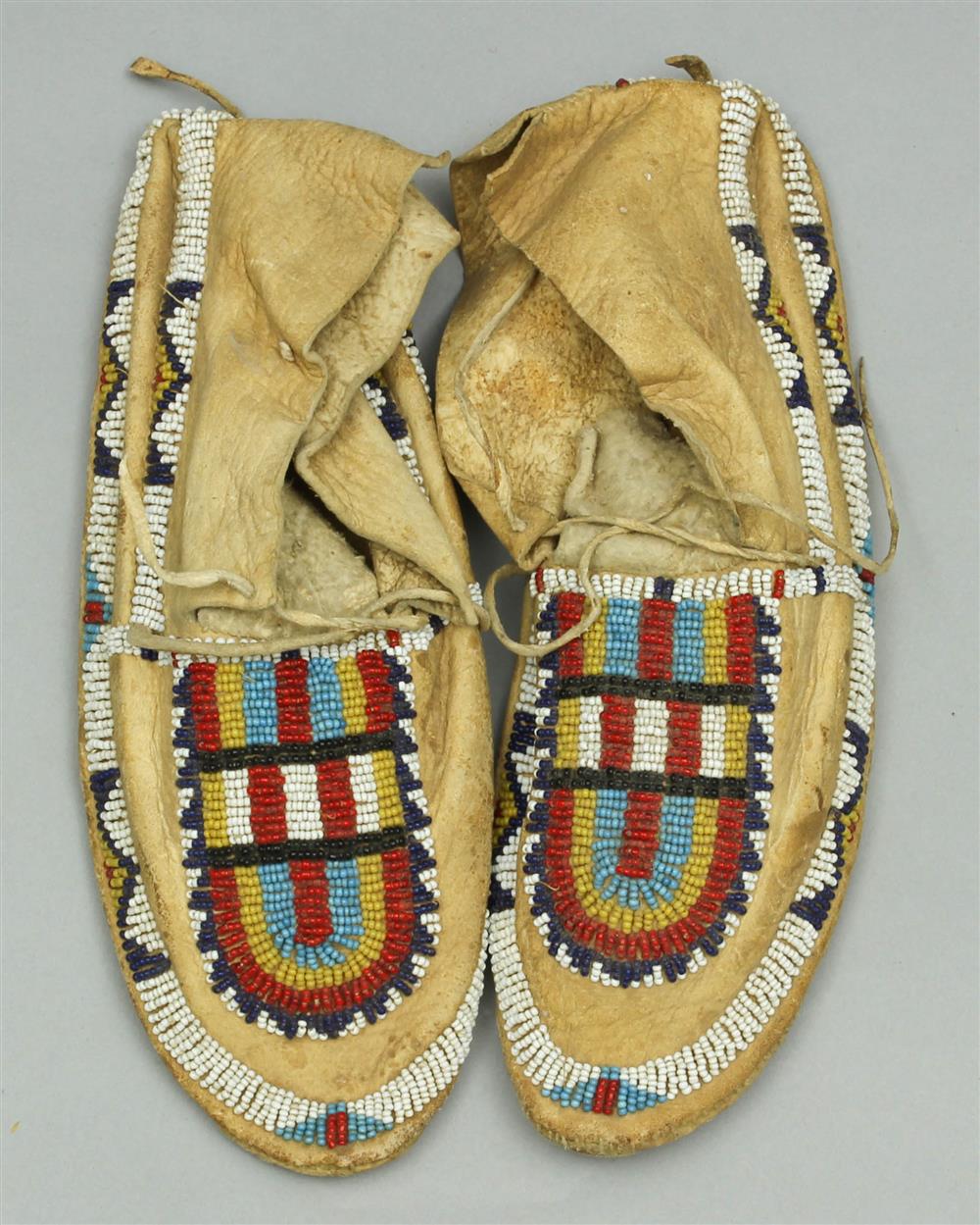 Appraisal: NATIVE AMERICAN BEADED HIDE MOCCASINS Central Plains Arapaho Cheyenne circa