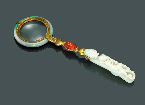 Appraisal: A metal jade and carnelian-mounted magnifying glass The handle including