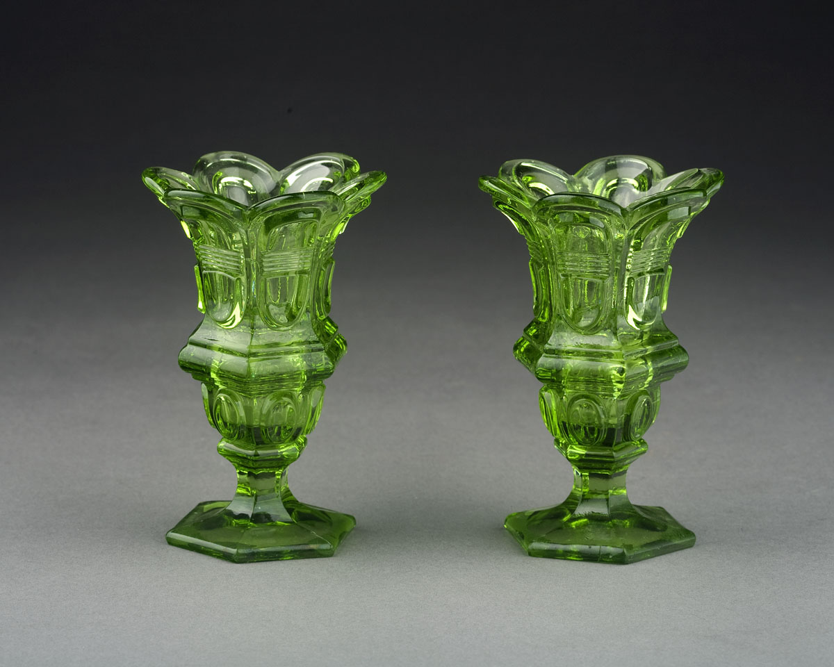 Appraisal: PAIR OF PRESSED TRANSPARENT GREEN 'ELONGATED LOOP WITH BISECTING LINES'