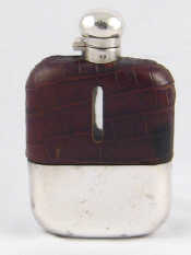 Appraisal: A leather cased silver plate mounted hip flask complete with