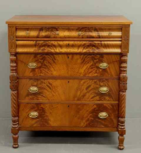 Appraisal: Empire mahogany chest of drawers with carved columns and turned