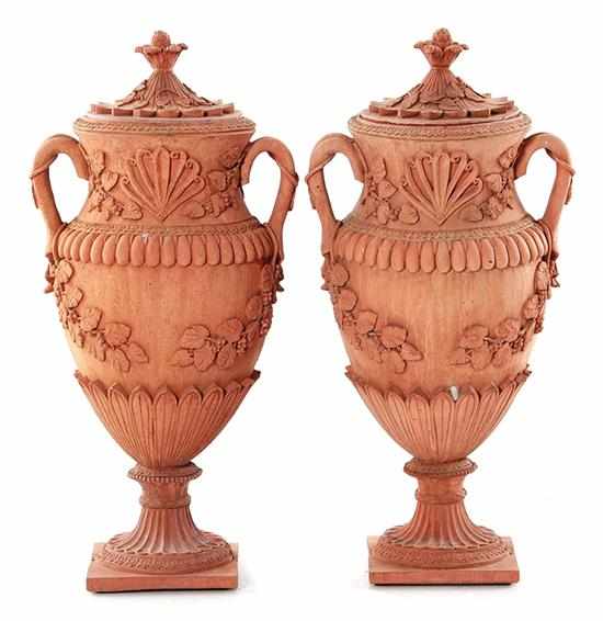 Appraisal: Pair cast-stone urns artichoke finial atop double-handled urn on square