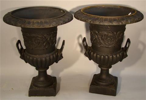 Appraisal: PAIR OF CAST IRON BLACK PAINTED URNS with everted egg