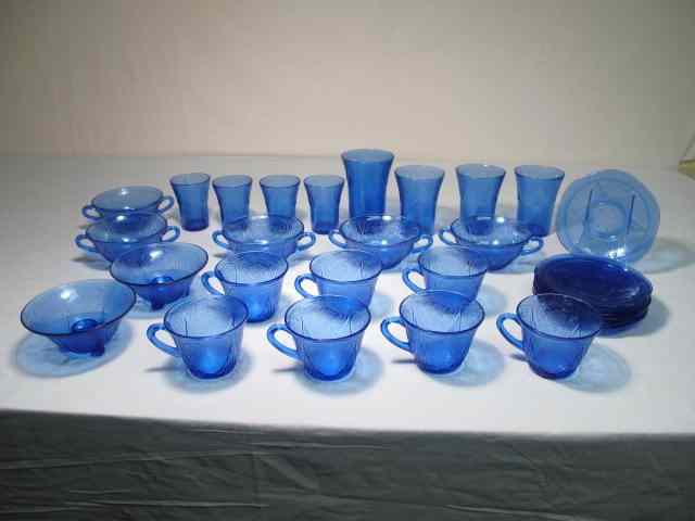 Appraisal: Cobalt blue glass dinnerware set pieces total Floral pattern Includes