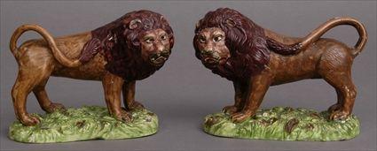 Appraisal: PAIR OF STAFFORDSHIRE FIGURES OF GROWLING LIONS Each mirror image