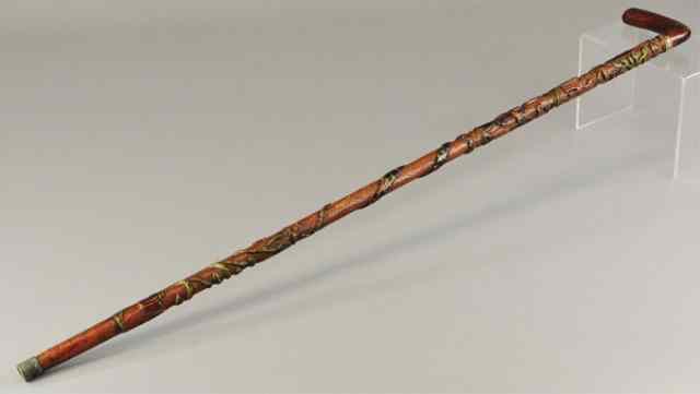 Appraisal: a WOOD CARVED CANE Extensive carving details features plants man