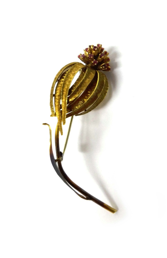 Appraisal: A gold and ruby set brooch designed as a flower