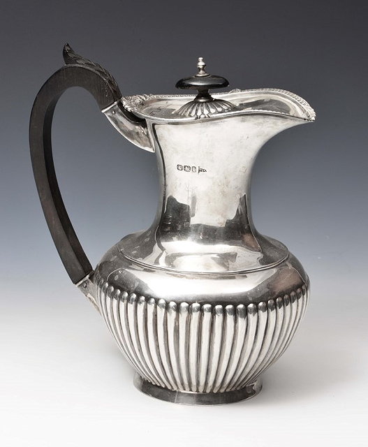 Appraisal: A LATE VICTORIAN SILVER BALUSTER SHAPED WATER JUG with fluted