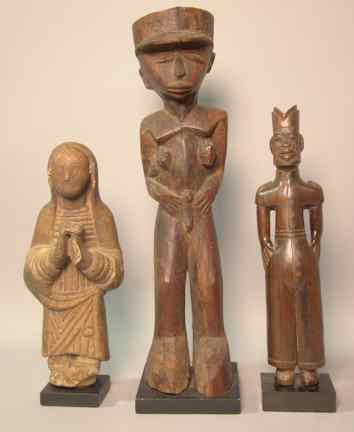 Appraisal: THREE CARVED FIGURES including a terra cotta figure praying approx