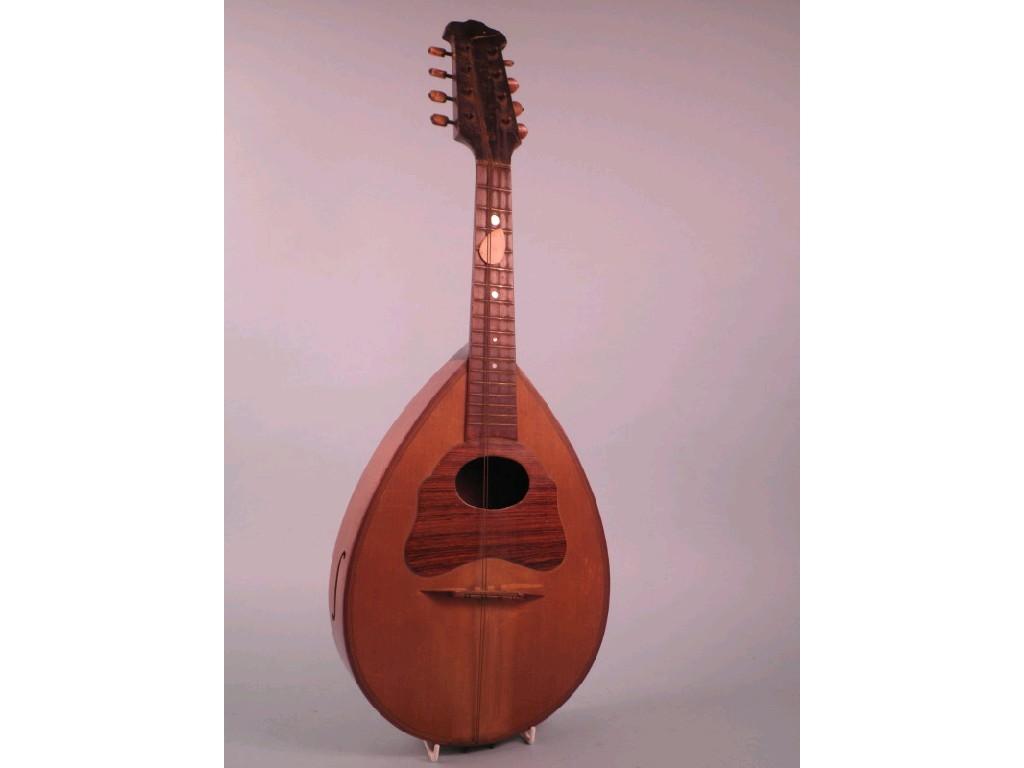 Appraisal: A continental fruitwood mandolin with rosewood mounts and stain bone