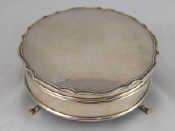 Appraisal: A silver velvet lined round jewellery box on three feet