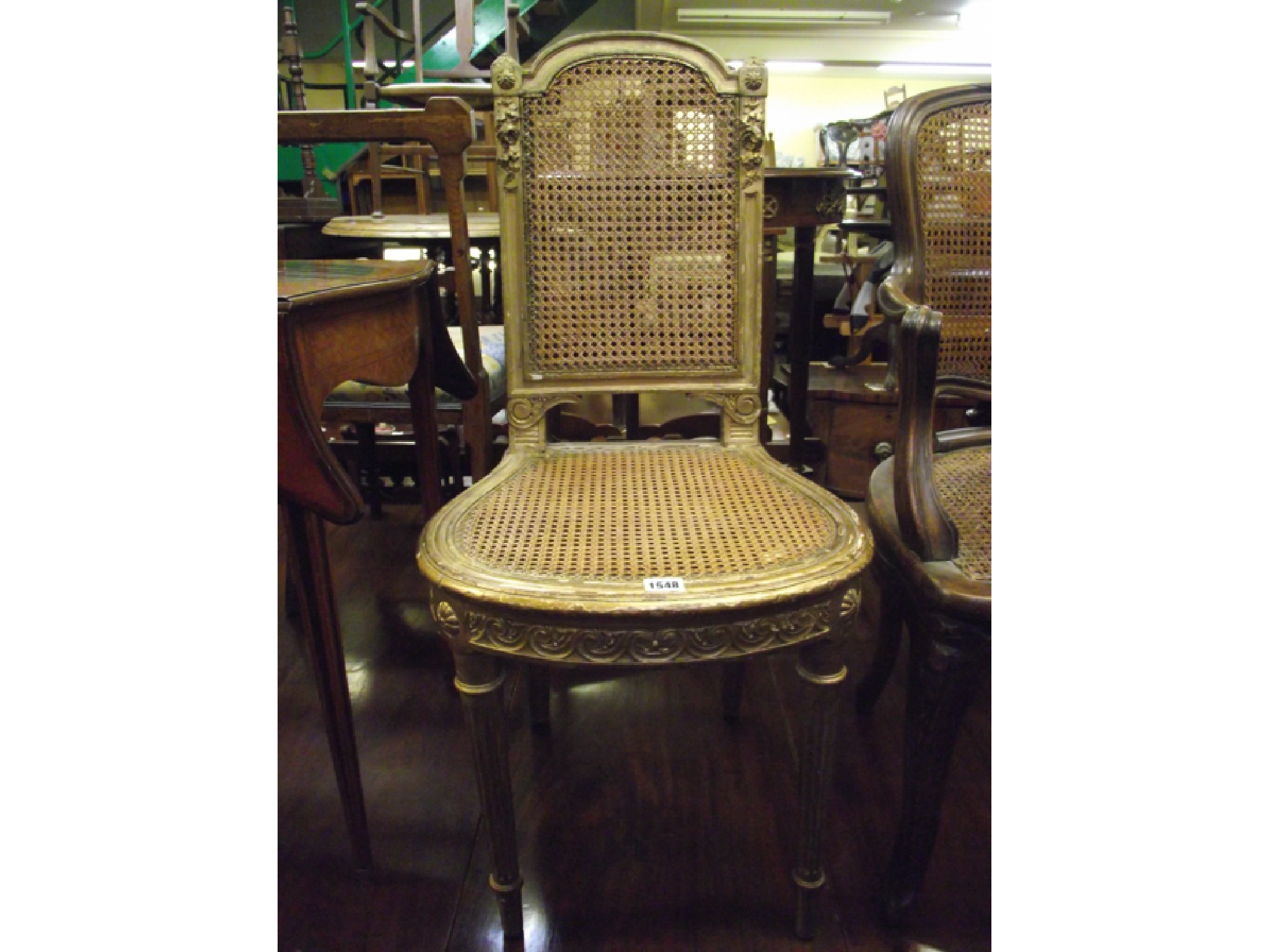 Appraisal: A th century French open armchair with cane panelled seat