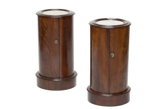 Appraisal: A pair of th century cylindrical mahogany bedside cupboards with