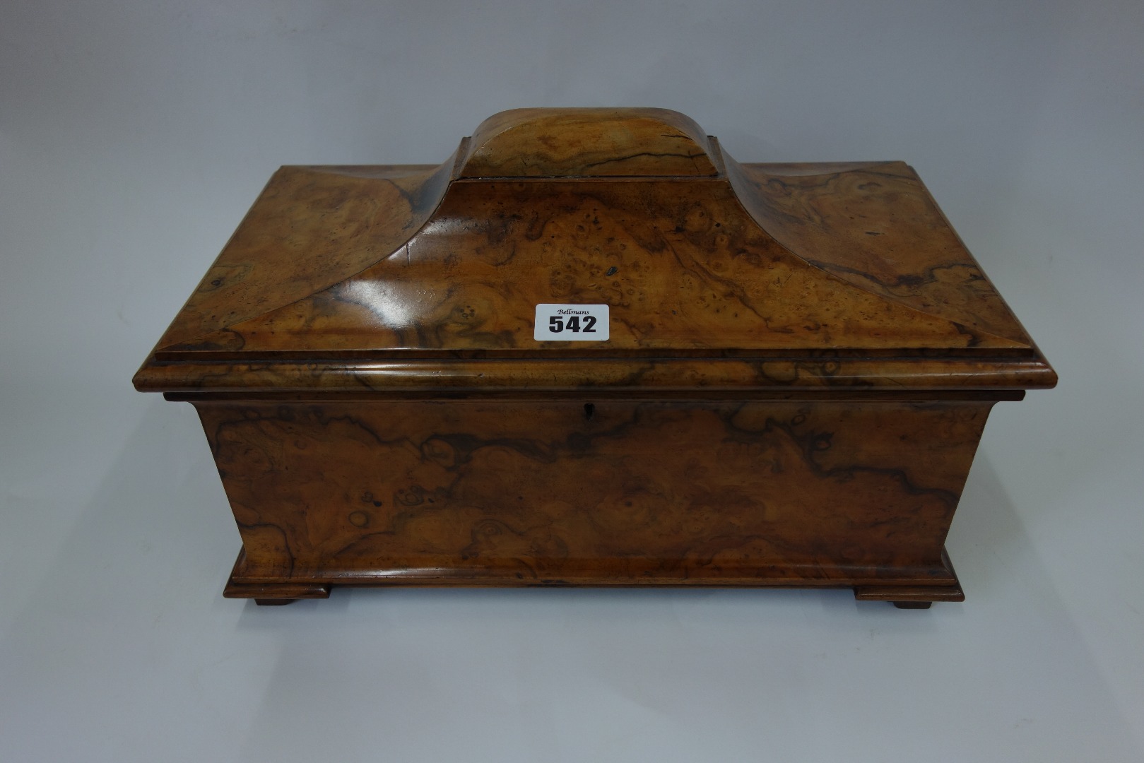 Appraisal: An early Victorian figured walnut sarcophagus tea caddy the hinged