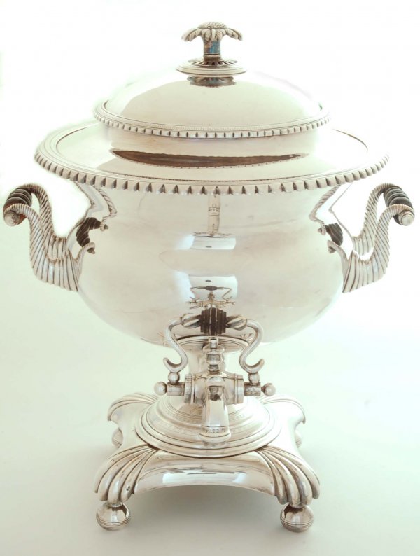 Appraisal: An English silverplated hot water urn Turned wood handles on