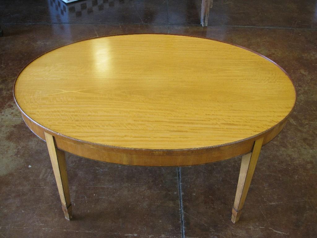 Appraisal: A Sheraton style satinwood oval low Table on square tapering