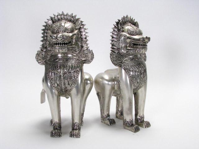 Appraisal: Pair of cast metal statuary depicting mythical guard animals Asian