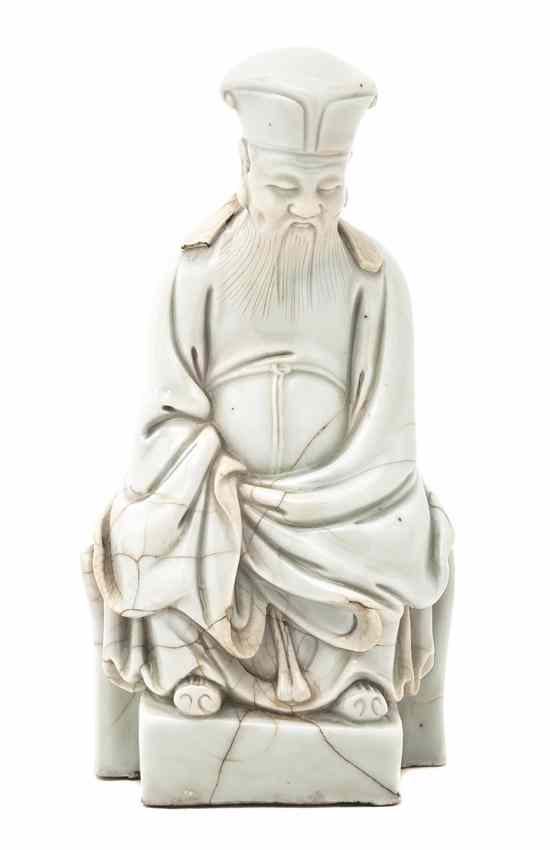 Appraisal: A Blanc de Chine Figure depicting a seated elderly gentleman