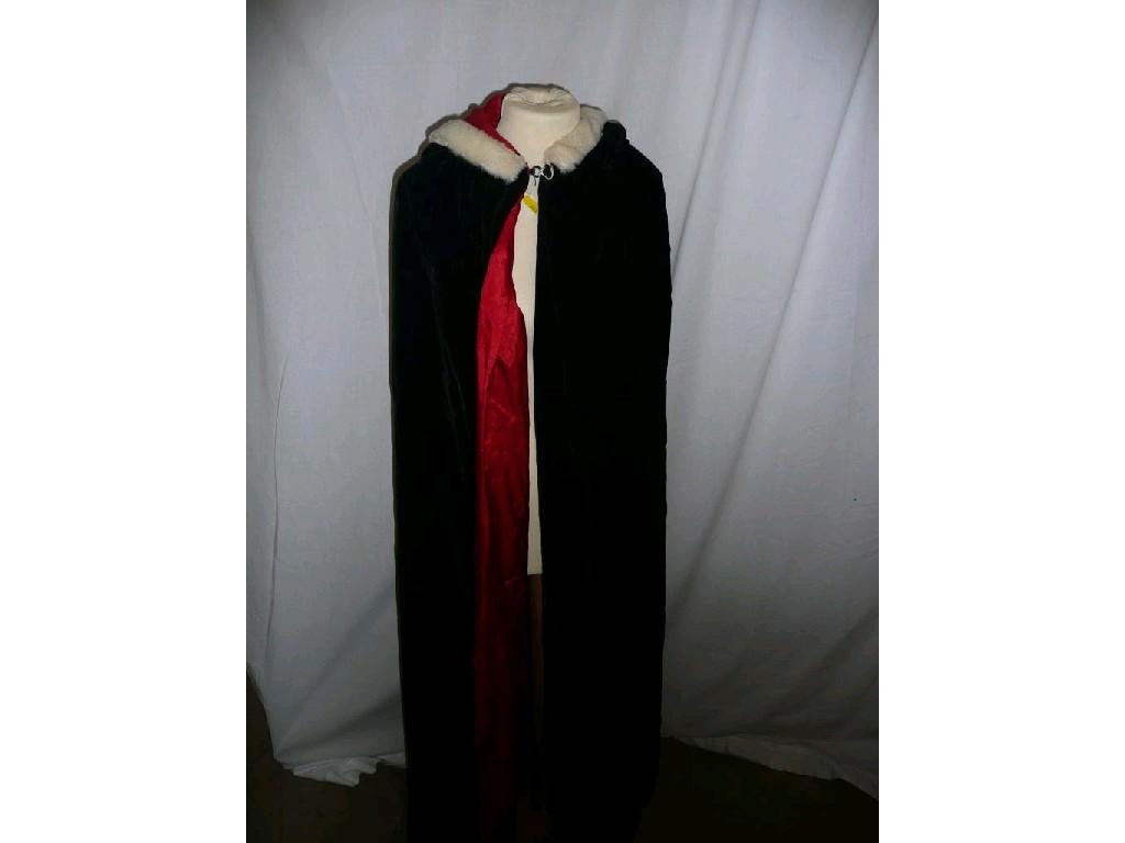 Appraisal: A lady's long black velvet cape lined with attached hood