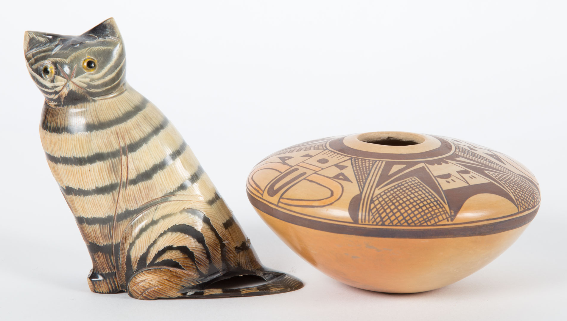 Appraisal: Pueblo pottery seed pot and a carved horn cat miniature