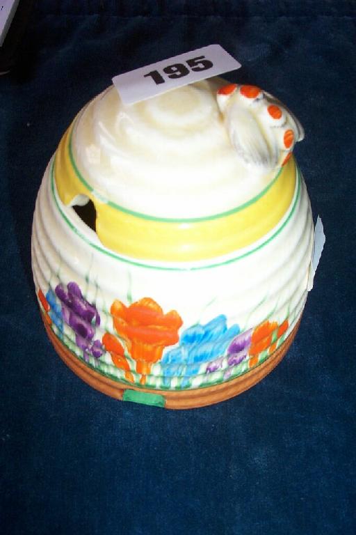 Appraisal: A Clarice Cliff honey pot and cover with rope twist