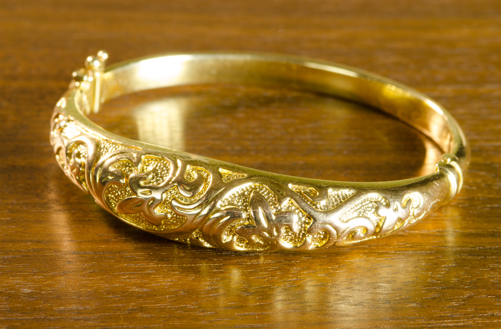 Appraisal: ITALIAN FOURTEEN KARAT GOLD BANGLE The yellow gold oval hinged