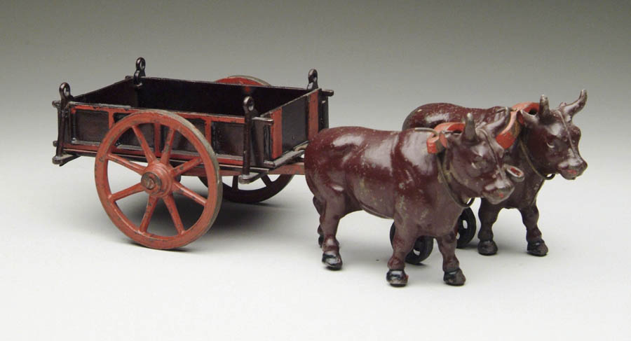 Appraisal: WELKER AND CROSBY OXEN CART Great looking toy Japanned cart