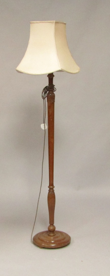 Appraisal: An early thC mahogany standard lamp with curved leaf and