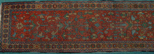 Appraisal: Rectangular red ground carpet runner profusely decorated with flowers cm