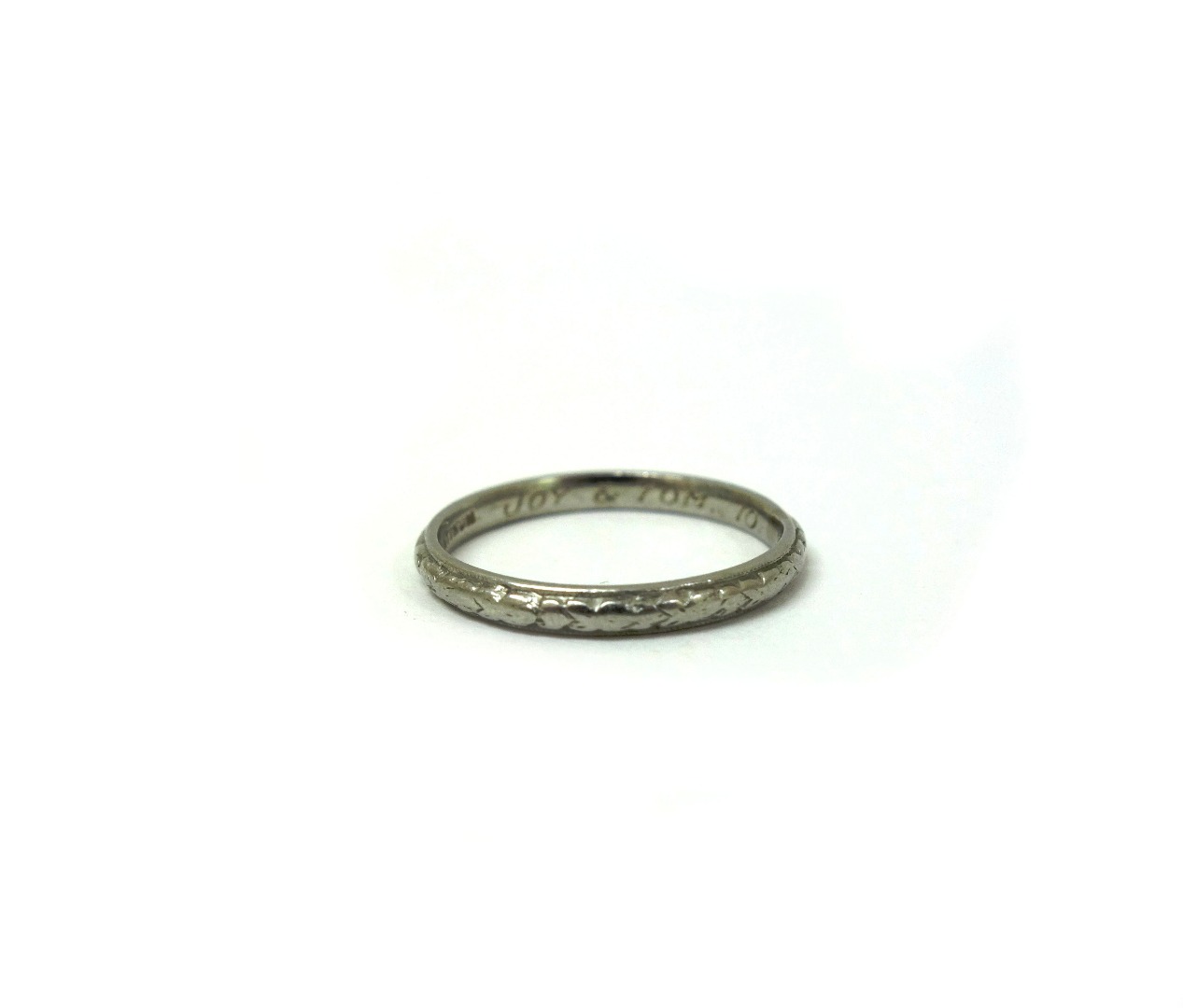 Appraisal: A platinum wedding band inscribed Platinum and 'Joy Tom '