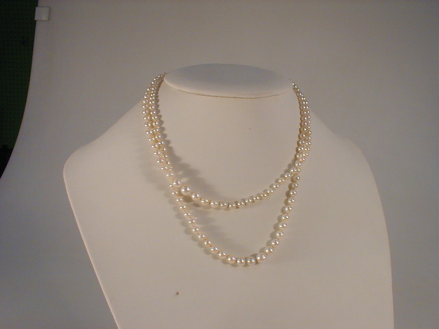 Appraisal: A double strand graduated cultured pearl necklace with silver and