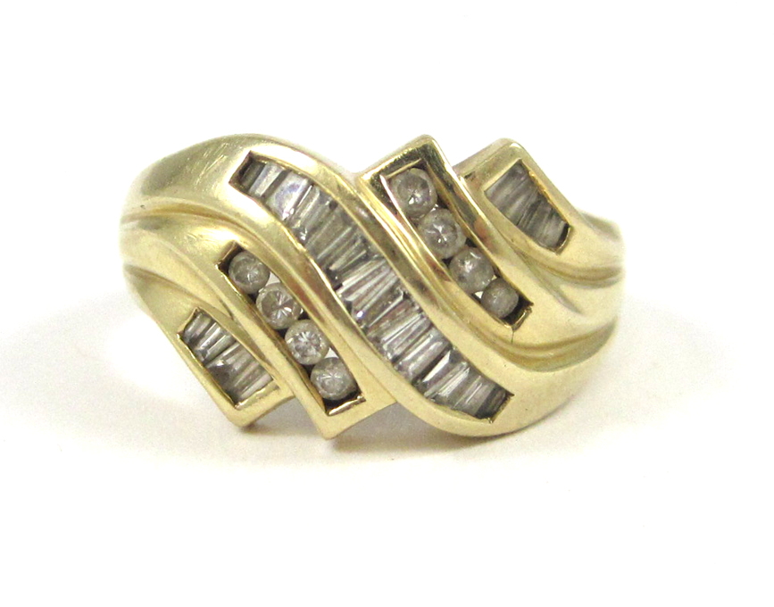 Appraisal: DIAMOND AND FOURTEEN KARAT GOLD RING channel set with eight