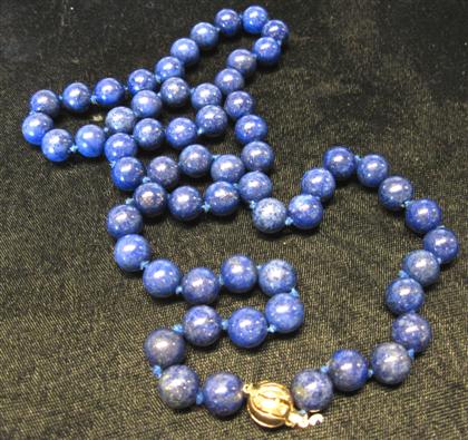 Appraisal: Single strand lapis necklaceDark blue lapis beads with karat yellow