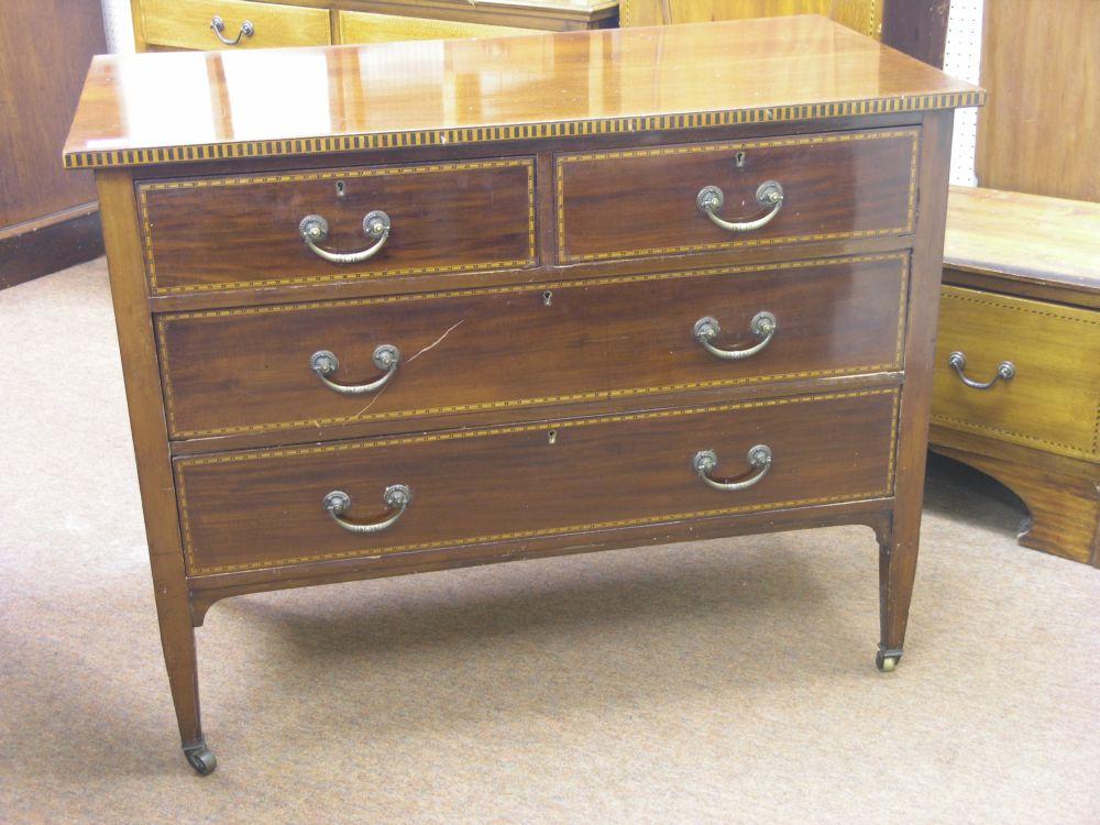 Appraisal: An Edwardian inlaid mahogany bedroom chest two short and two