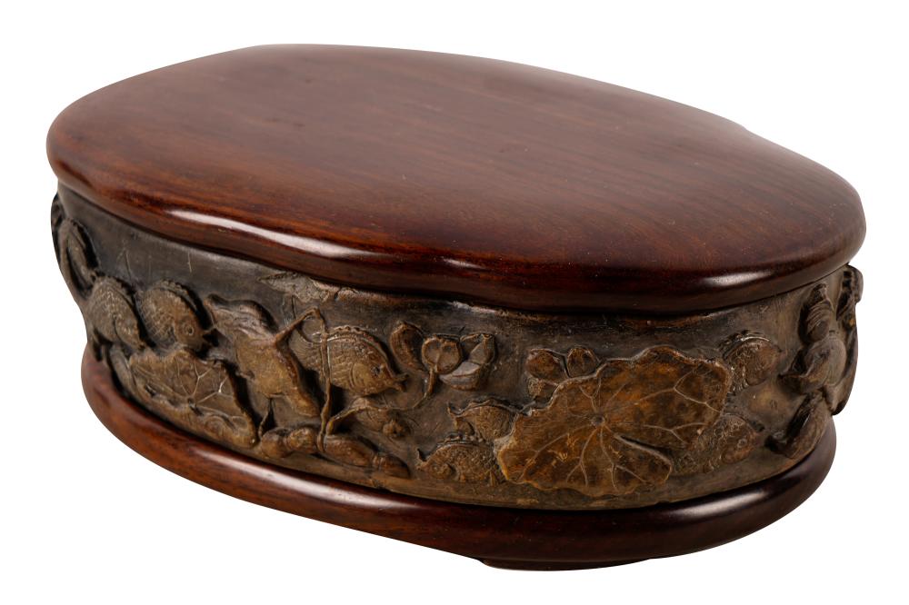 Appraisal: CARVED INKSTONEdepicting marine life with polished wood stand and cover