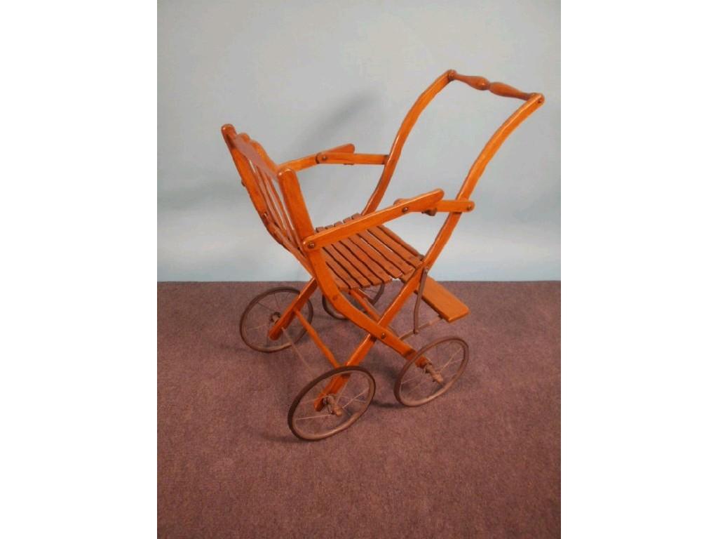 Appraisal: An early thC turned beech child's folding push chair