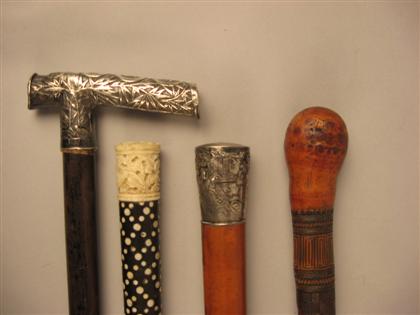 Appraisal: Group of four Asian walking sticks th th century Comprising