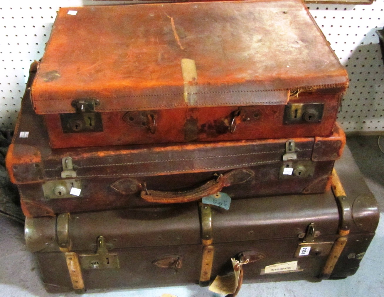 Appraisal: A group of three brown leather suitcases