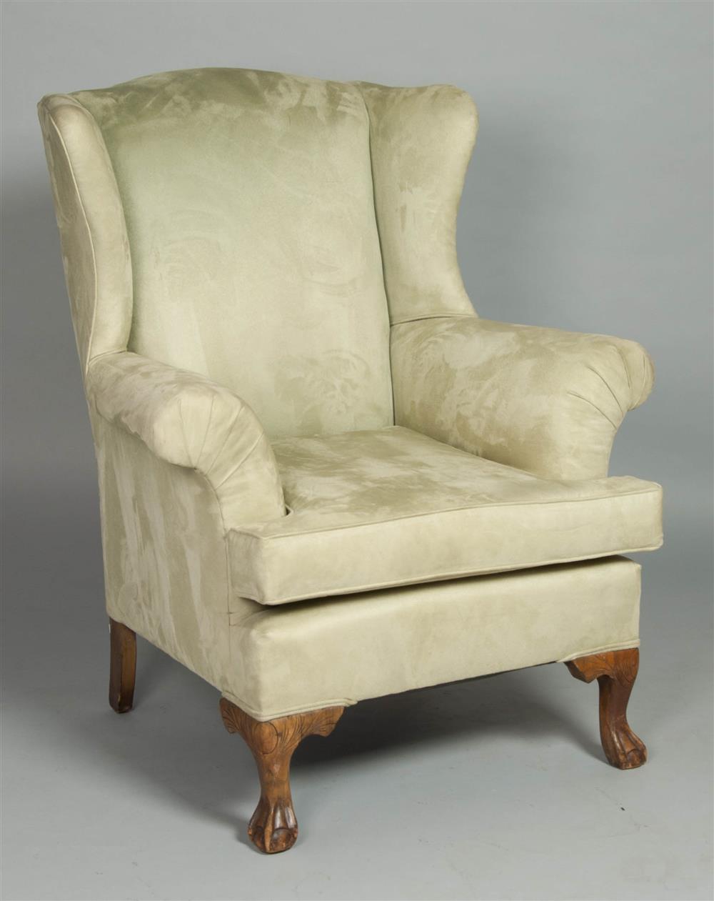 Appraisal: GEORGE III STYLE UPHOLSTERED WING CHAIR having an arched back