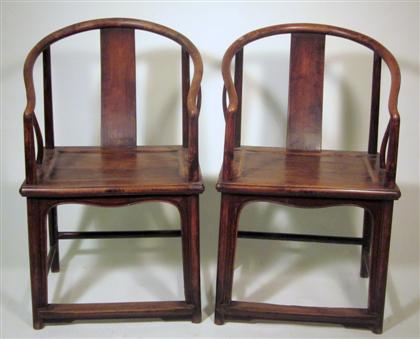 Appraisal: Pair of Chinese hardwood horseshoe back armchairs late th early