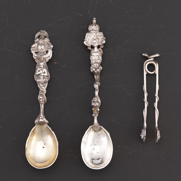 Appraisal: PAIR OF CONTINENTAL HERALDIC SPOONS AND MEDUSA DESIGN SUGAR TONGS