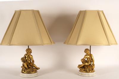 Appraisal: A pair of table lamps with gilt putto bases cm