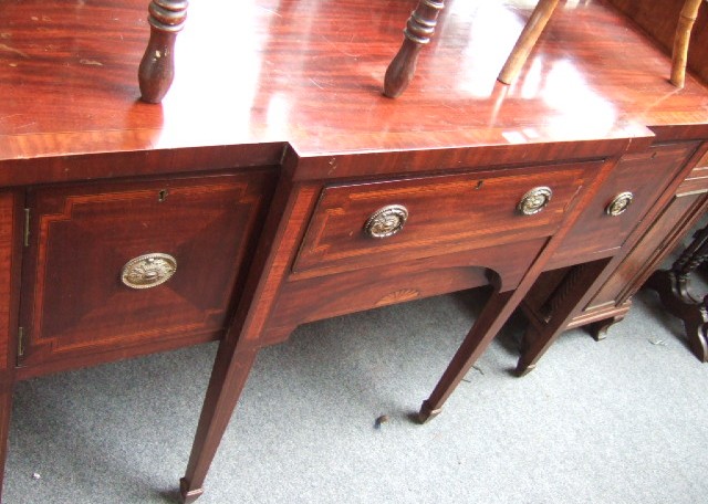 Appraisal: An Edwardian mahogany and satinwood banded breakfront sideboard with a