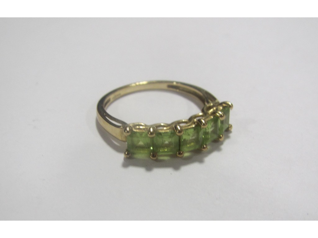 Appraisal: Nine carat gold peridot five stone ring