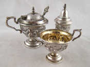 Appraisal: A white metal tests silver cruet set with spoon embossed